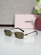 MiuMiu glasses with gold frame, olive tinted lenses, black temple arms