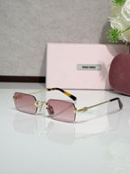 MiuMiu glasses with gold frame, rose tinted lenses, tortoise temple detail