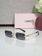 MiuMiu glasses with gold frame, smoky blue tinted lenses, tortoise temple tips