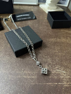 Chrome Hearts pendant necklace draped with flower charm and square cross pendant