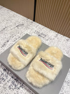 Faux fur slide sandals with Balenciaga logo on cream straps