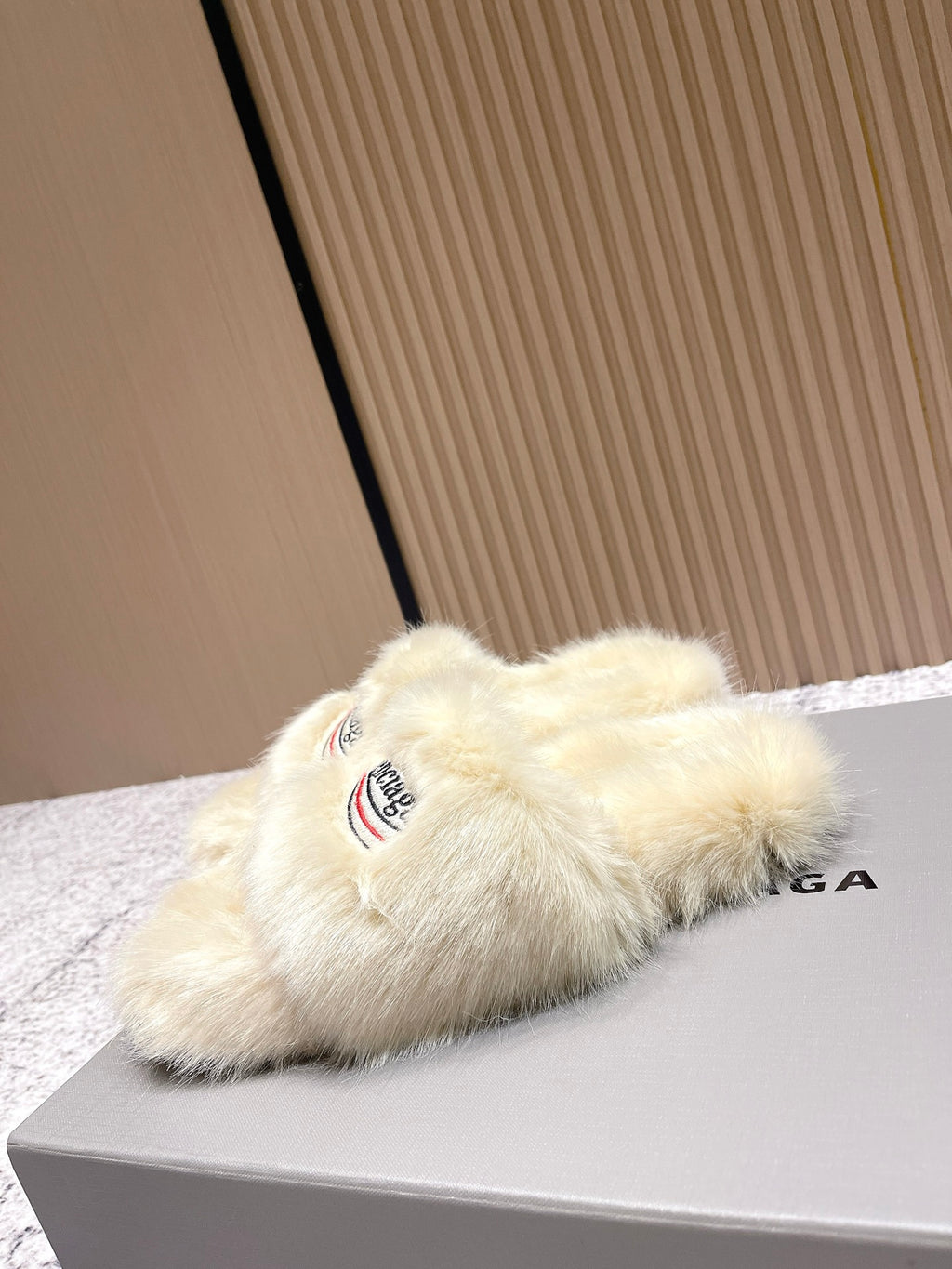 Faux fur slide sandal with Balenciaga logo on cream strap