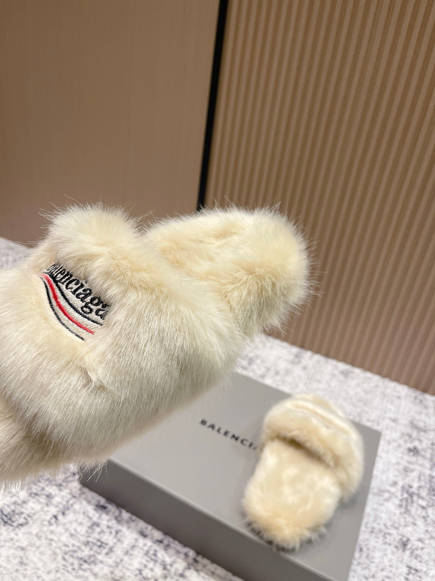 Faux fur slide sandals with Balenciaga logo on cream straps
