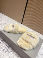 Faux fur slide sandals on box lid, cream straps with Balenciaga logo