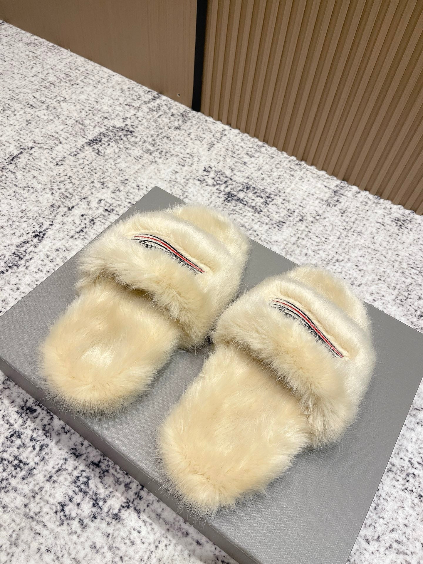Faux fur slide sandals with Balenciaga logo on cream padded straps