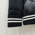 Ribbed knit sleeve cuff with white striped band on dark puffer jacket