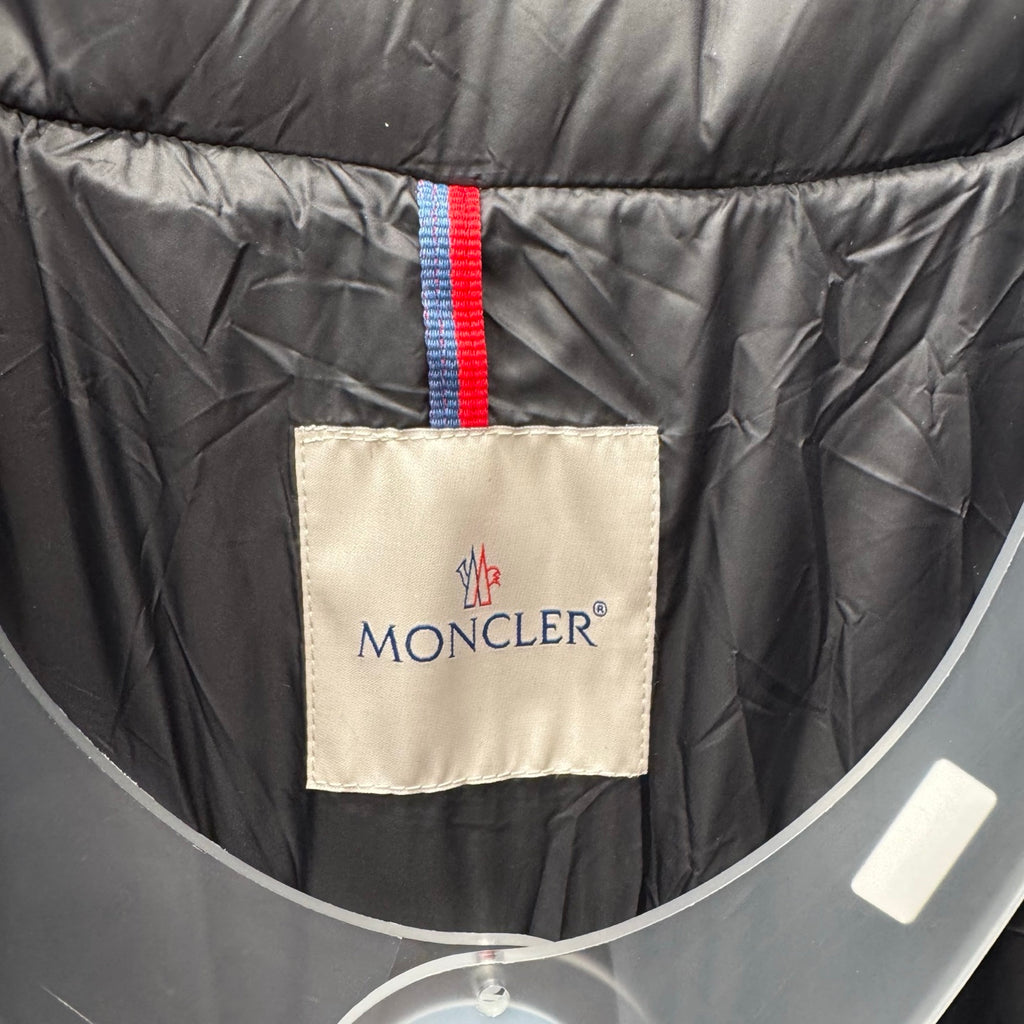 Puffer jacket interior brand label with red hanging tab, dark lining