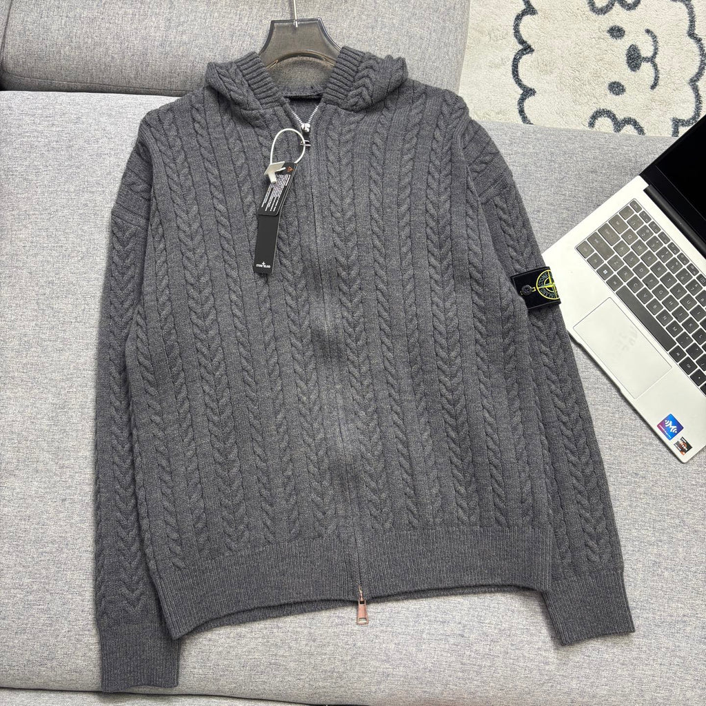 Gray cable-knit zip hoodie with hood, ribbed cuffs and hem on couch