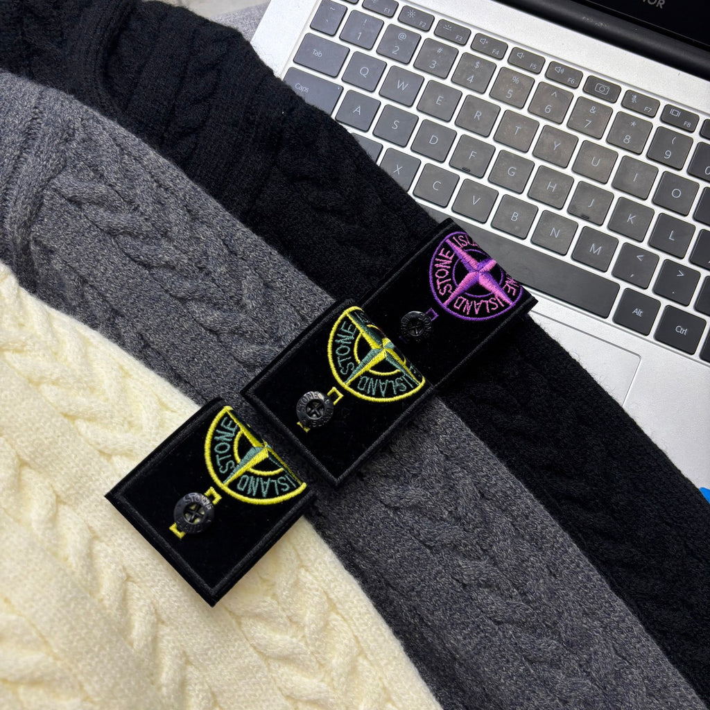 Cable-knit fabric swatches in dark gray and cream with product tags