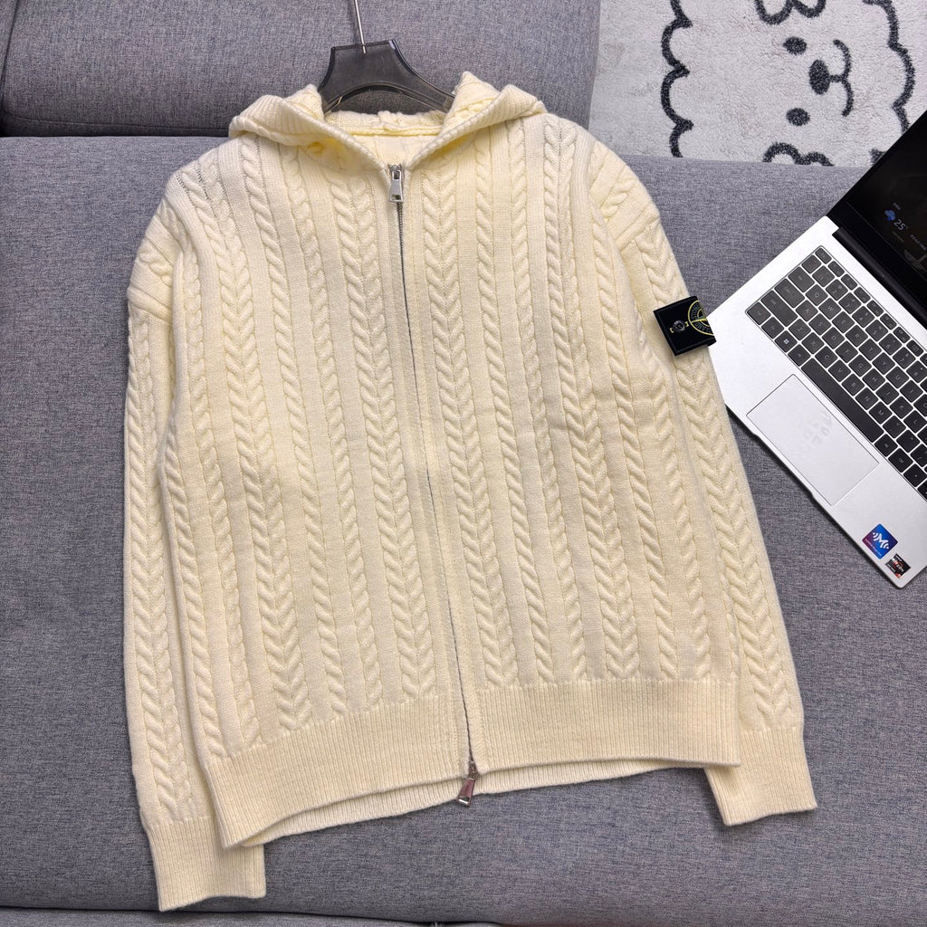 Cream cable-knit zip hoodie with hood, ribbed cuffs and hem on couch
