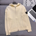 Cream cable-knit zip hoodie with hood, ribbed cuffs and hem on couch