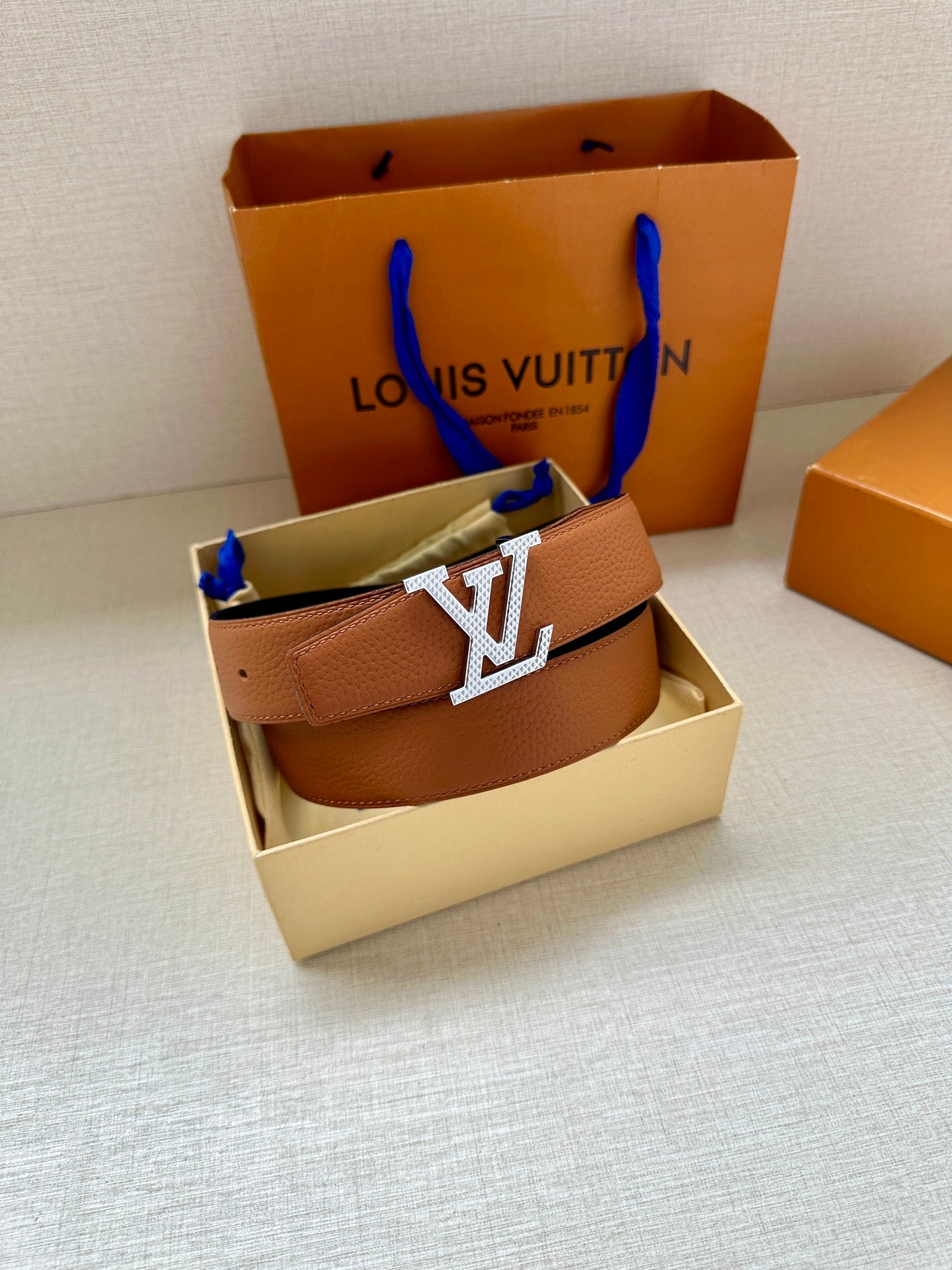 Louis Vuitton tan leather belt with gold-tone LV buckle and belt keeper