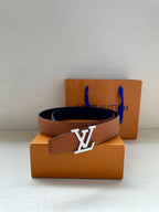 Louis Vuitton tan leather belt with gold-tone LV buckle on display