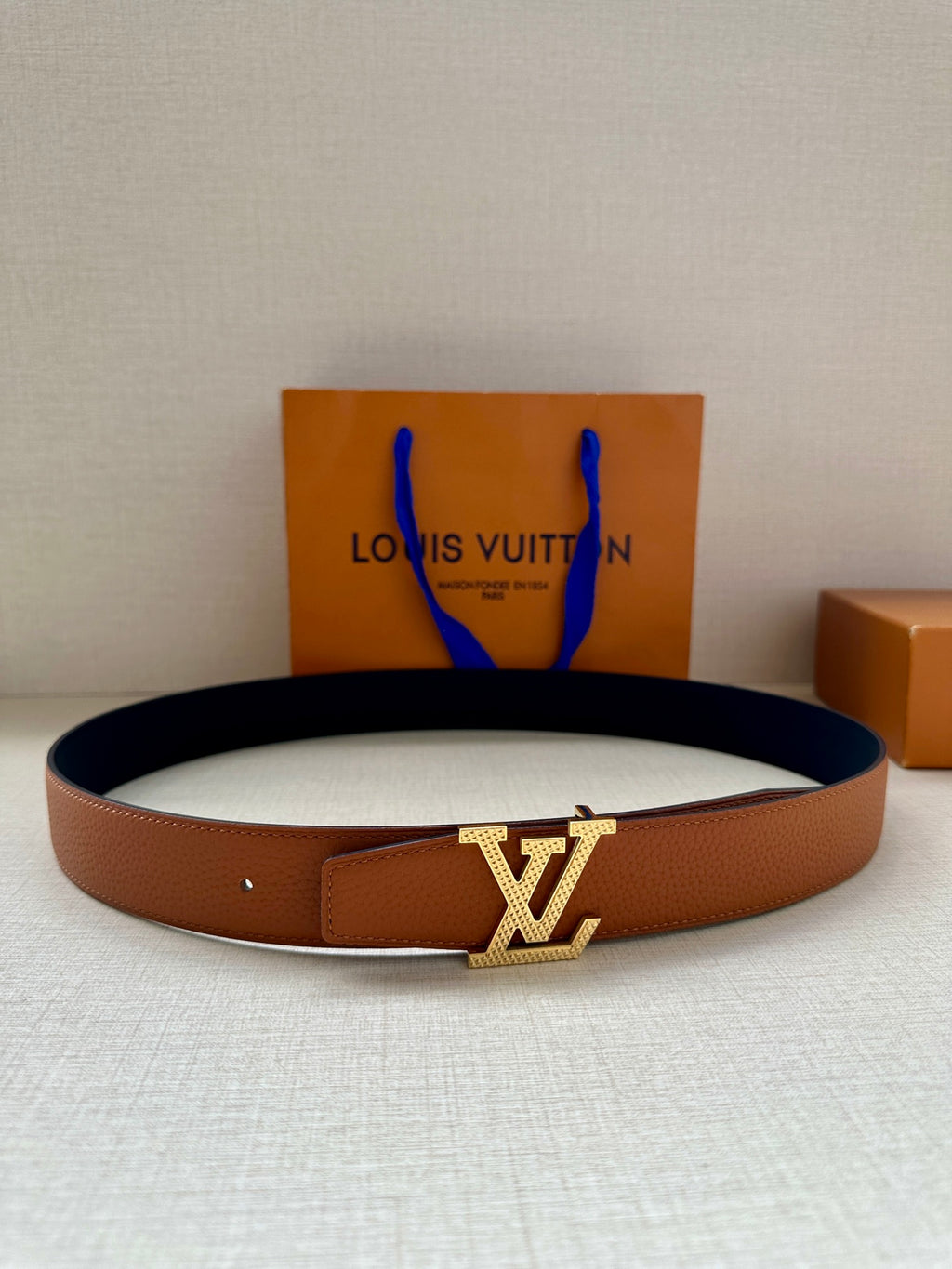 Louis Vuitton leather belt in tan with gold-tone LV buckle plaque