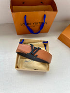 Louis Vuitton belt in box, tan leather strap with LV silver buckle and dark edge