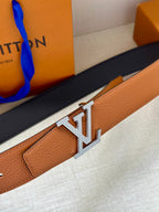 Louis Vuitton belt close-up with LV silver buckle on tan leather strap