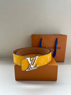 Yellow monogram belt with gold-tone LV buckle, flat front view