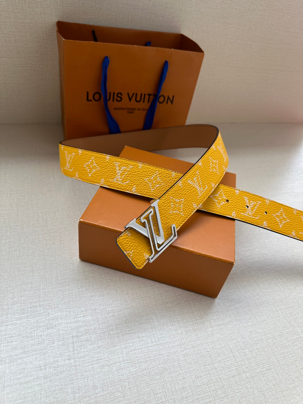 Yellow monogram belt with gold-tone LV buckle, folded strap view