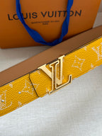 Yellow monogram belt, close-up of gold-tone buckle and keeper