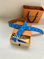 Blue Louis Vuitton belt with monogram weave, LV buckle, and tan leather side
