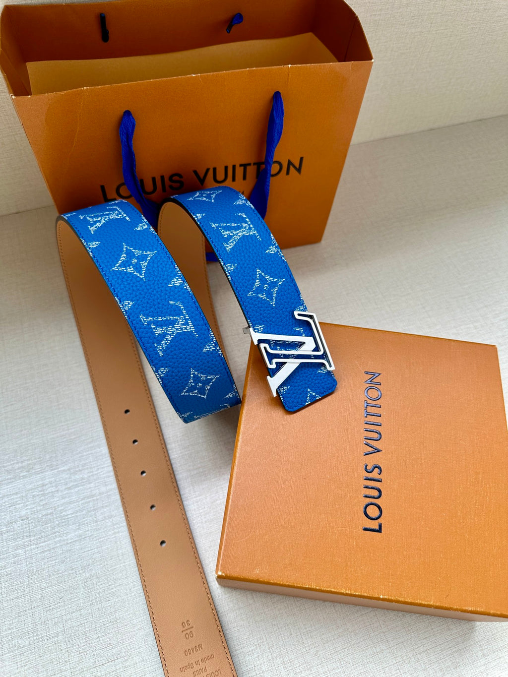 Blue monogram belt with silver LV buckle and tan leather belt strap