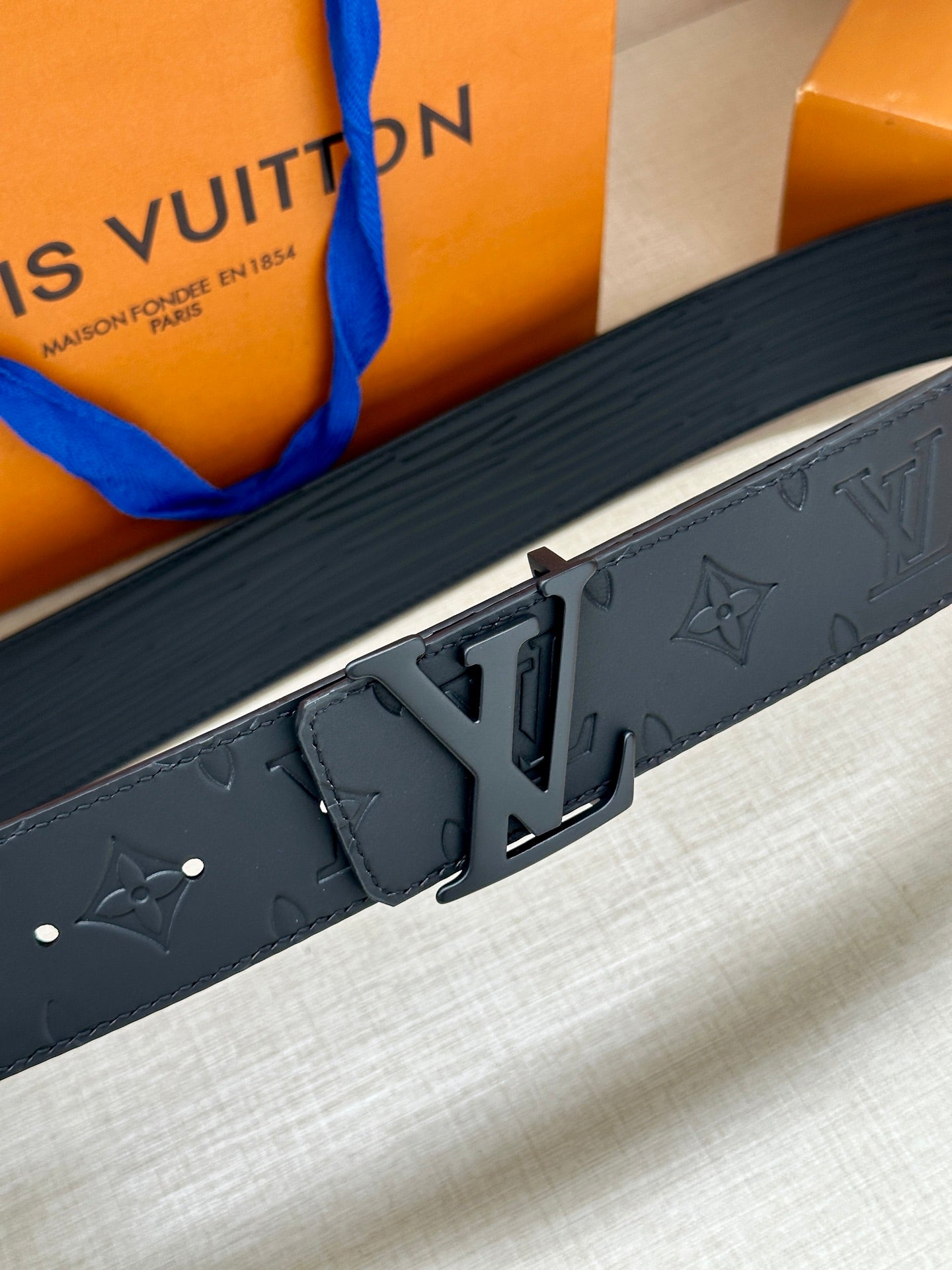 Louis Vuitton monogram belt with large dark LV buckle detail