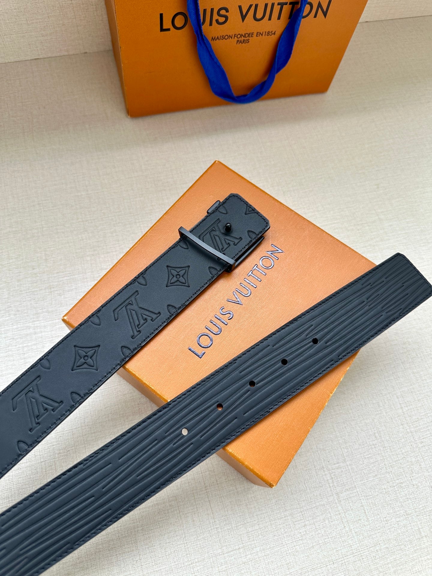 Louis Vuitton monogram belt with rectangular LV buckle and patterned strap