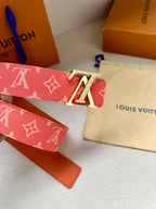 Louis Vuitton belt with red monogram canvas and gold-tone LV buckle, showing strap edges