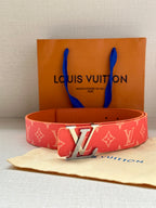 Louis Vuitton belt front view: red monogram strap with gold-tone LV buckle