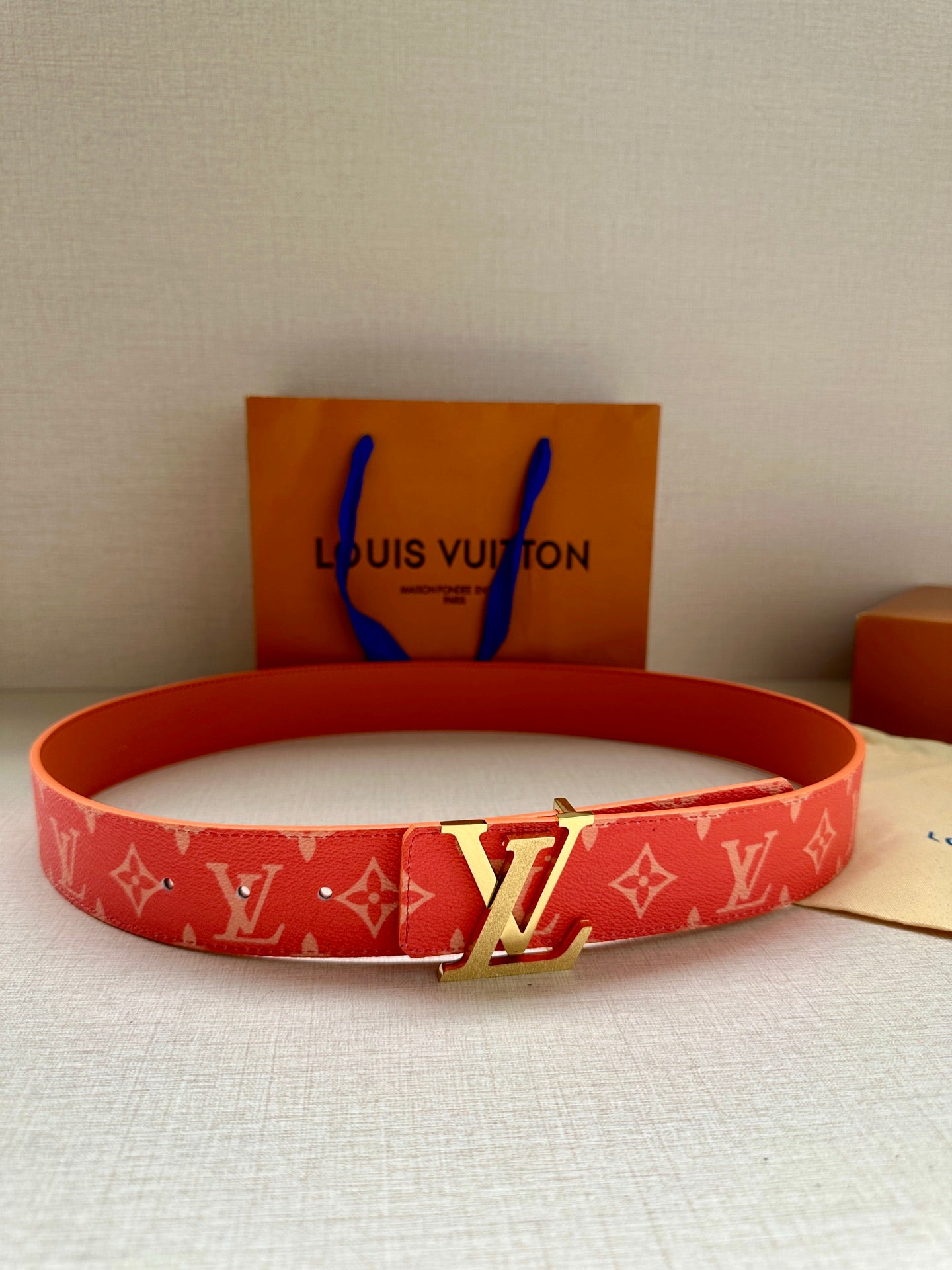 Louis Vuitton belt in red monogram canvas with gold-tone LV buckle and punched holes