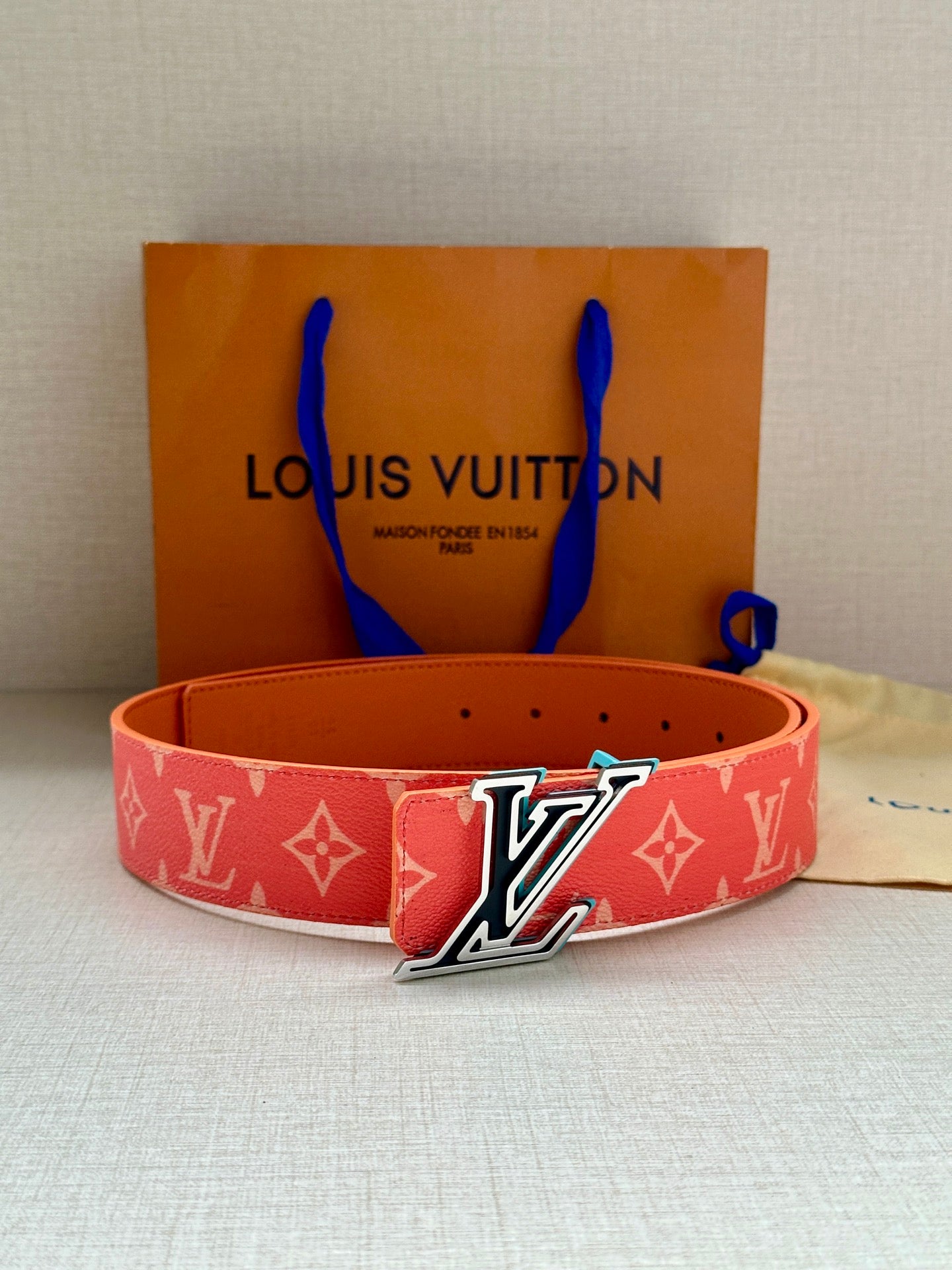 Louis Vuitton belt in red monogram canvas with prominent LV buckle