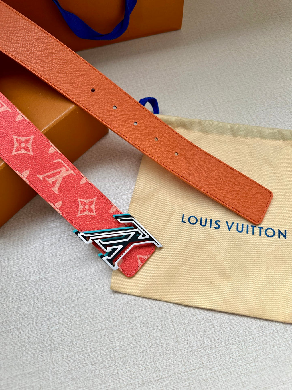 Louis Vuitton leather belt in orange with silver-tone LV buckle and punched holes