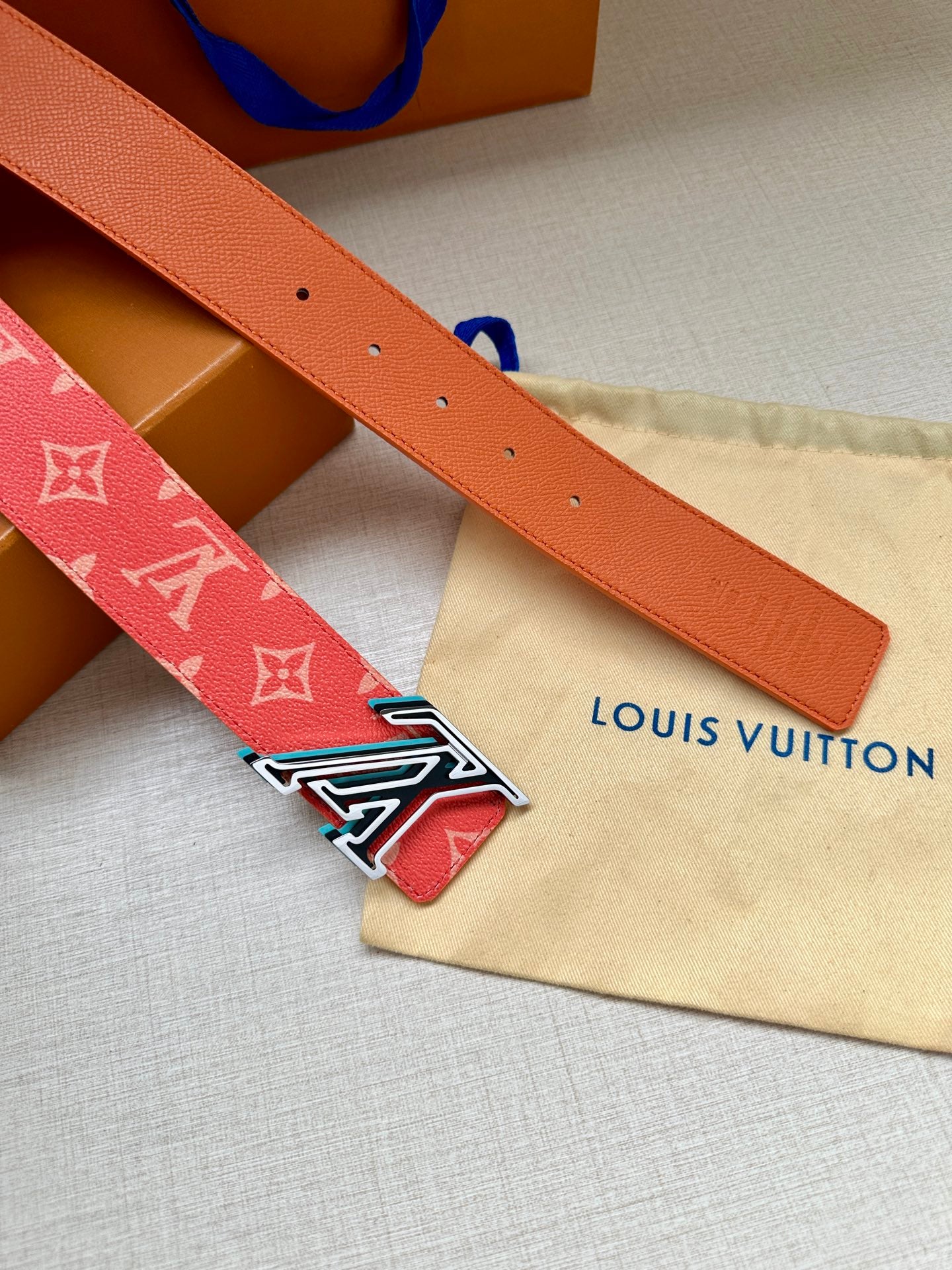 Louis Vuitton leather belt in orange with silver-tone LV buckle and punched holes