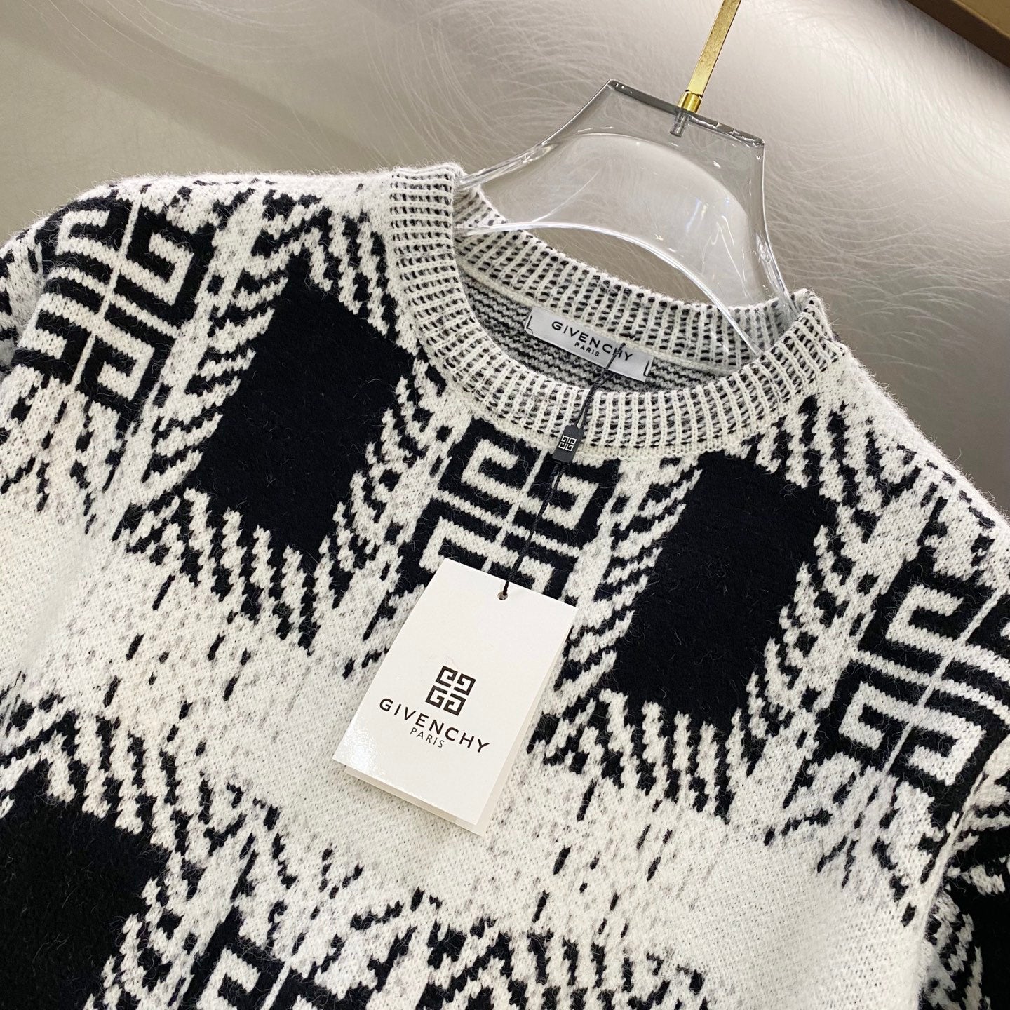 Givenchy knit sweater front, black-and-white geometric pattern, crew neck