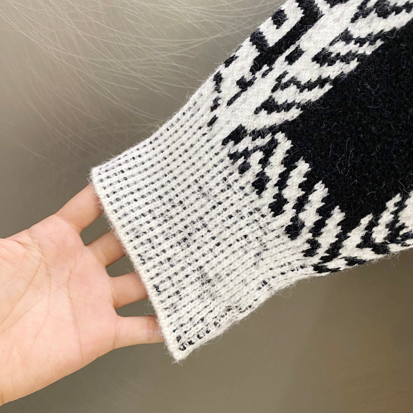 Givenchy knit sweater cuff and knit texture, black-and-white geometric pattern