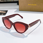 Bvlgari cat-eye sunglasses, burgundy frames, red-tinted lenses, gold emblem bridge