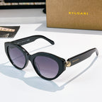 Bvlgari cat-eye sunglasses, black frames, purple-tinted lenses, gold emblem bridge