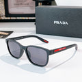 Prada glasses with dark frames and dark tinted lenses, red temple detail