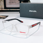Prada glasses with white frames and clear lenses, red logo temple detail