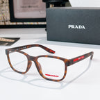 Prada glasses with tortoiseshell frames and clear lenses, red logo temple detail