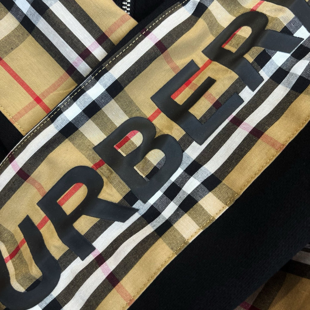 Plaid hood panel fabric with large black letters and red accents