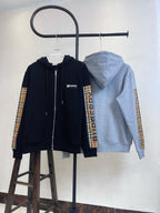 Zip-up hoodies: navy front and light gray back view, plaid sleeve panels.