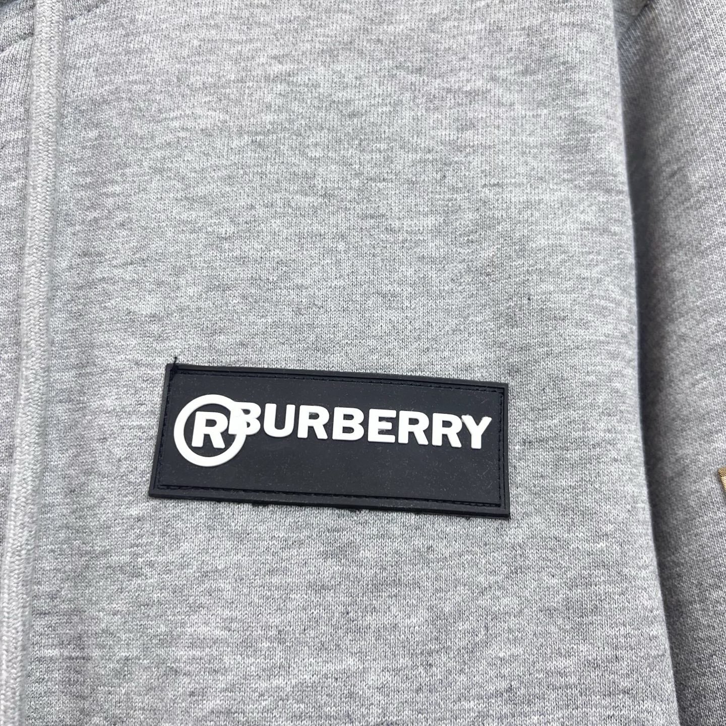 Gray hoodie chest logo patch reading RBURBERRY.