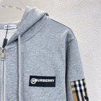Gray zip hoodie with drawstring hood, Burberry logo patch and plaid sleeve panel.
