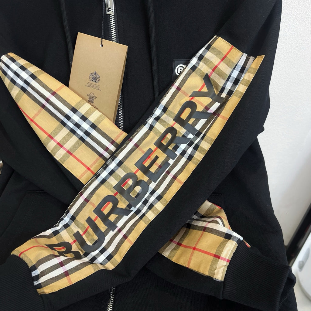 Black hoodie sleeve and hood panel with Burberry check pattern and logo print
