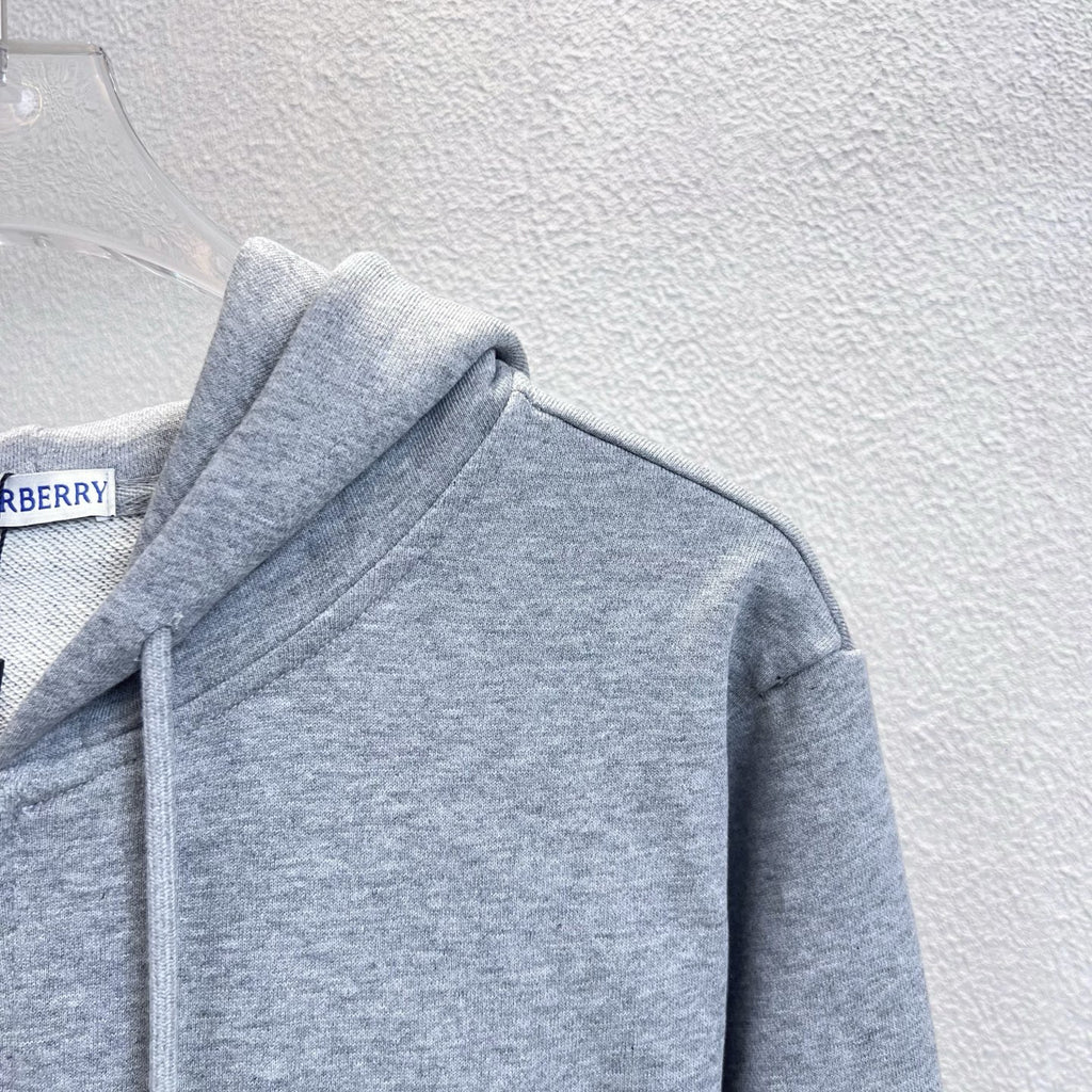 Gray hoodie shoulder and hood with drawstrings; Burberry label at neck.