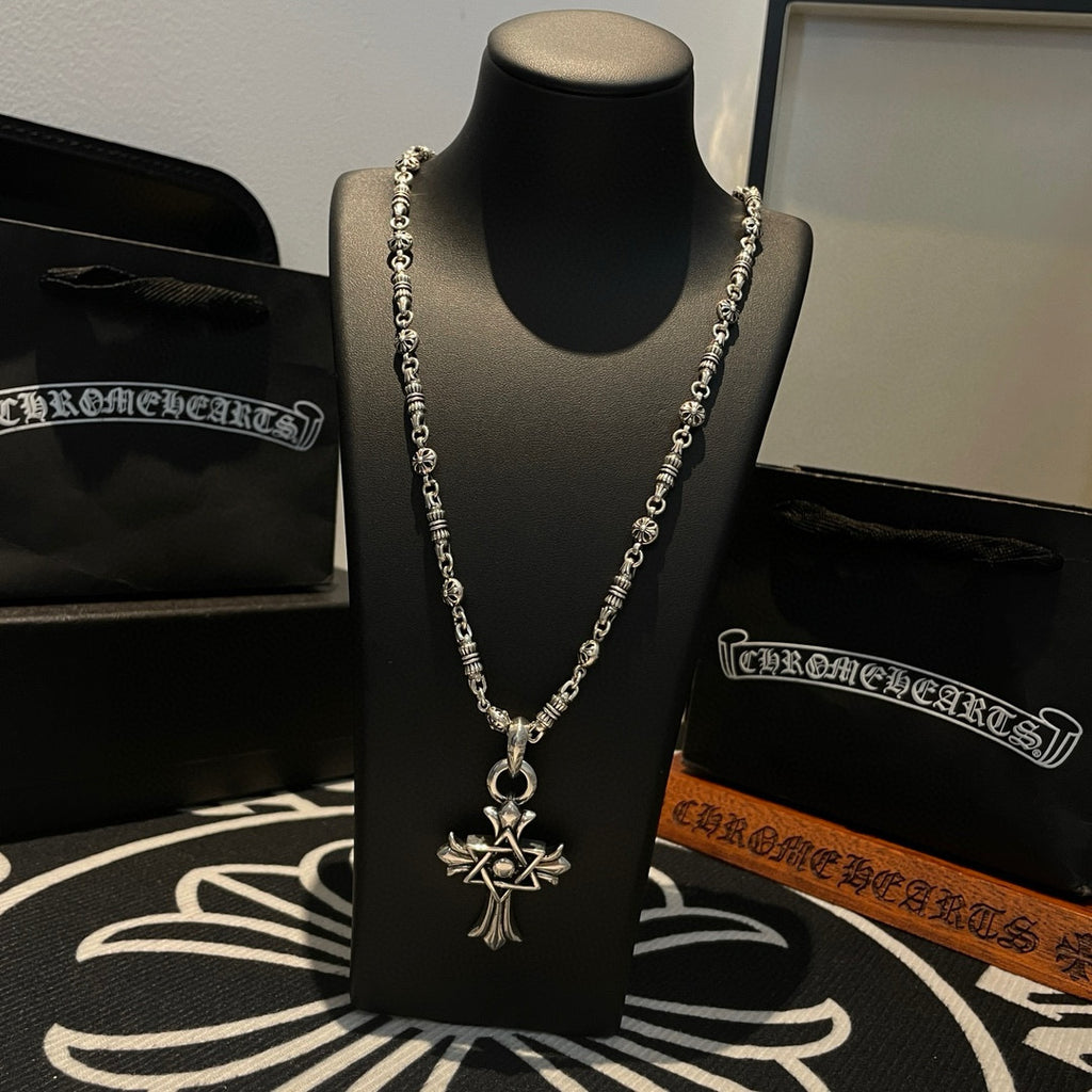 Silver-tone chain necklace with cross star pendant centered on the chain