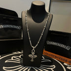 Silver-tone chain necklace with cross star pendant centered on the chain