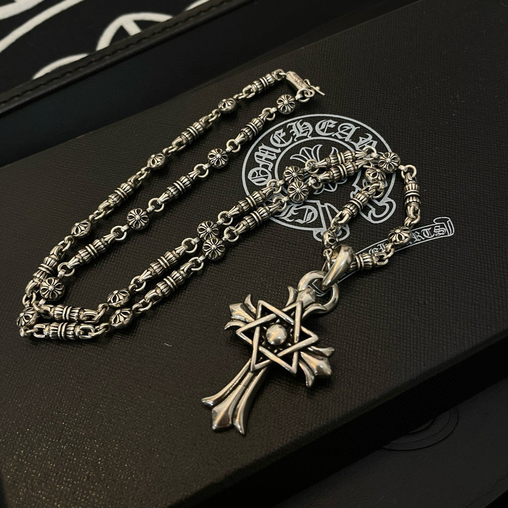 Silver-tone chain necklace with cross star pendant and ornate clasp detail