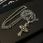 Silver-tone chain necklace with cross star pendant and ornate clasp detail